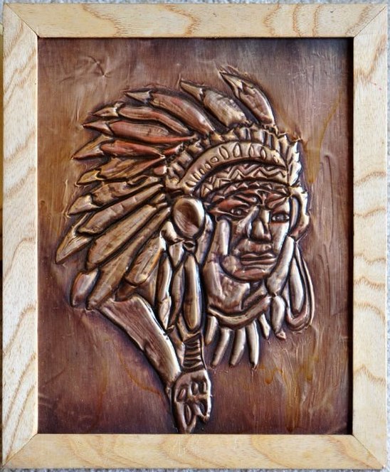 Embossed copper foil artwork depicting a Native American in headdress