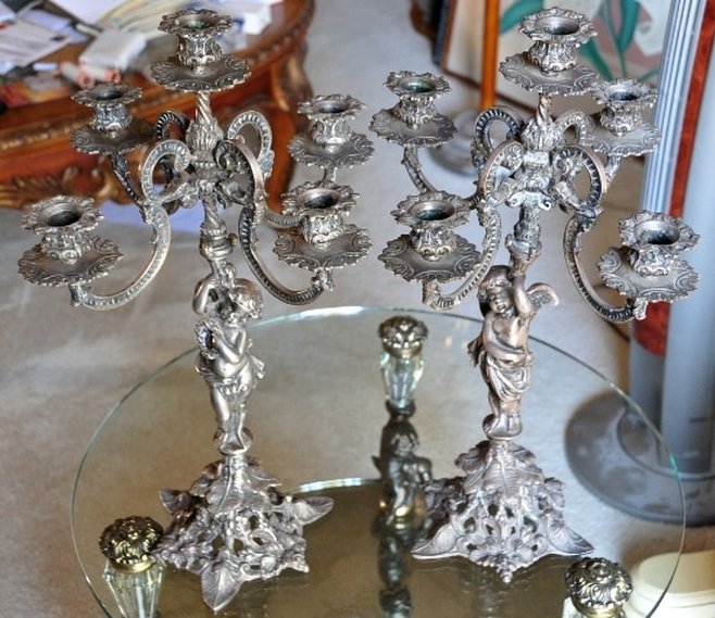 Pair of ornate metal candelabra with figural bases