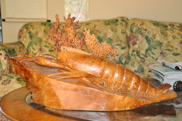 Lobster sculpture carved from a single piece of burl wood