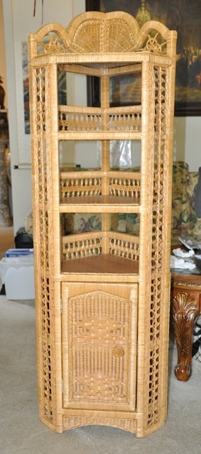 Wicker and wood corner stand of unique design with multiple shelves and a cabinet