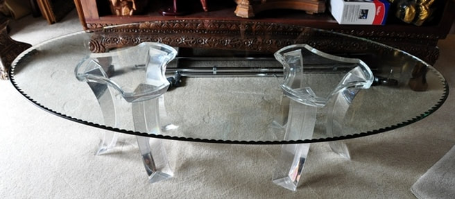 Oval glass top modern coffee table with acrylic pedestals