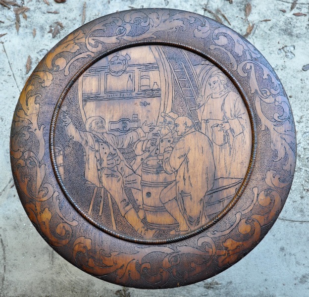 Large wooden plaque with etched artwork of people drinking in a pub