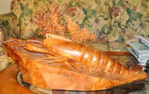 Lobster sculpture statue carved from a single piece of burl wood