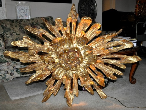 Golden sunflower shaped wall art with back lighting from mid-century