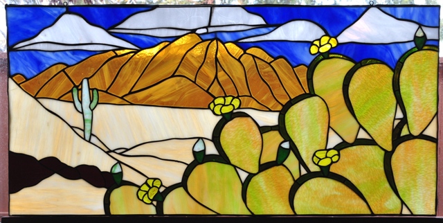 Stained glass window with desert scenery and cactus