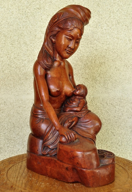 Hardwood carved sculpture from Bali of a woman breastfeeding her baby