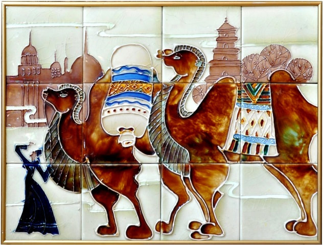Framed hand painted ceramic tile artwork depicting a desert oasis scenery