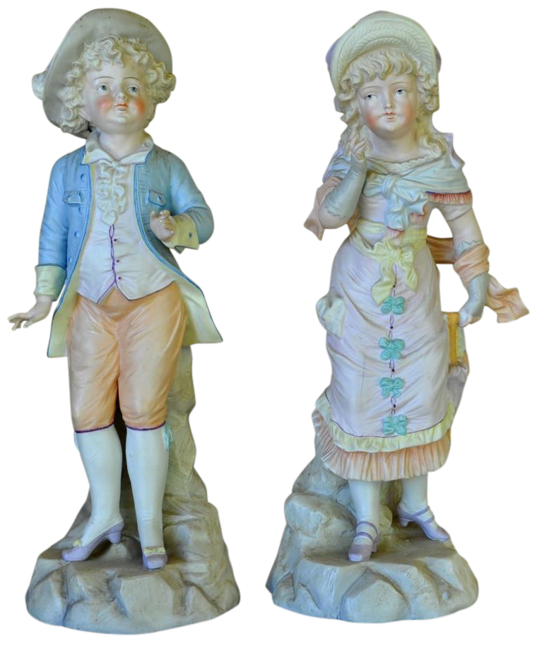 Pair of German bisque porcelain figures of a boy and a girl