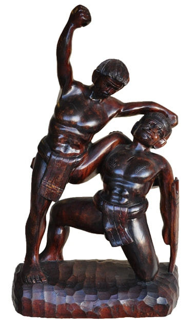 Balinese hardwood sculpture of two figures in combat