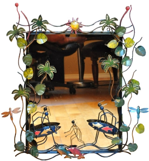 Metal framed mirror with tropical themed decorations