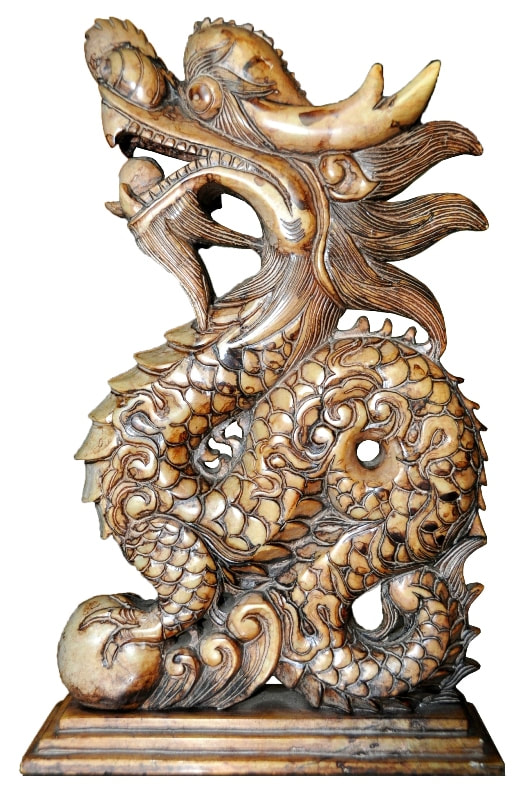Marble sculpture of a dragon holding pearls in its paw and mouth
