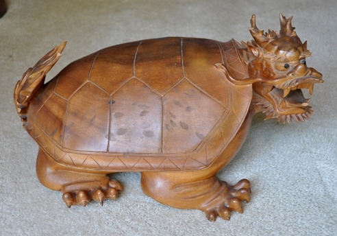 Large wood carved sculpture of a dragon turtle