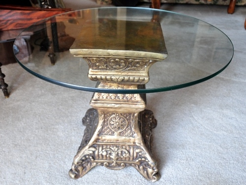 Indian antique end table with ornate brass pedestal base and glass top