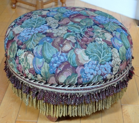 Colorful tapestry upholstered round Ottoman with fringe