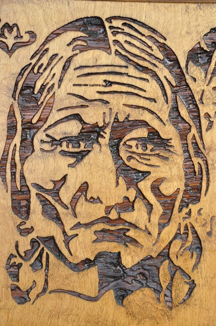 Framed relief carved wood panel depicting a Native American Indian chief
