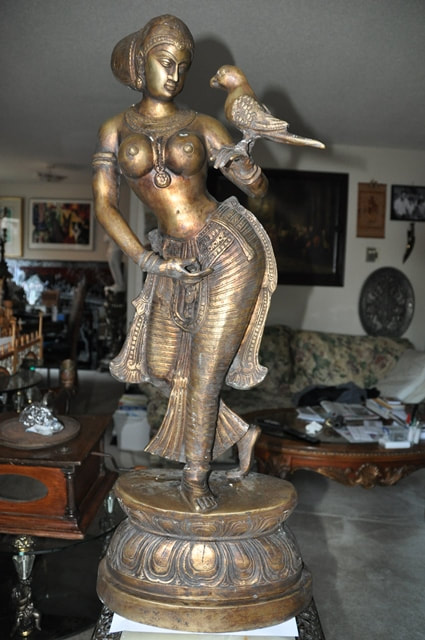 Antique brass sculpture of an Indian lady holding a parrot on her