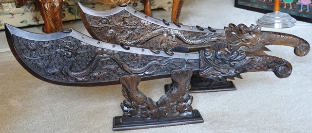 Pair of Vietnamese carved wooden swords with dragons on Koi fish stands
