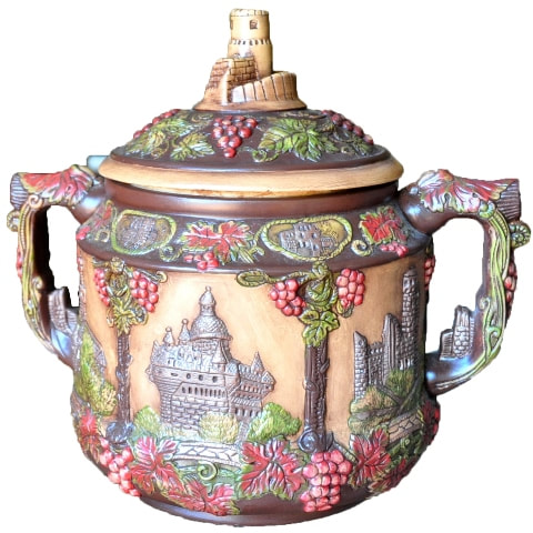 Vintage German pottery cookie jar with relief features depicting castles