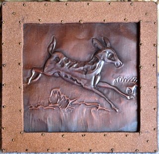 Embossed copper foil artwork depicting a deer