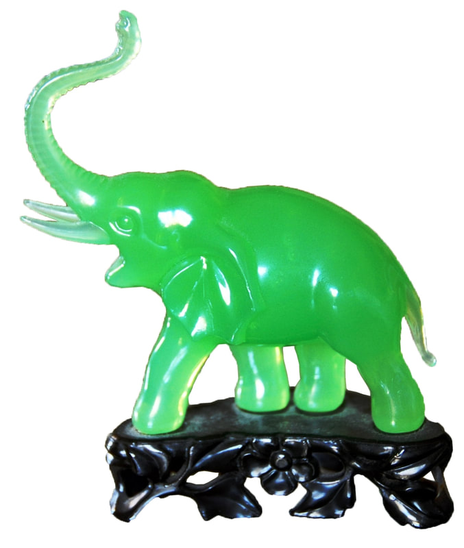 Vintage faux jade elephant figurine with raised trunk