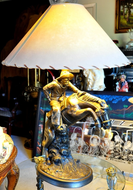 Pair of table lamps with sculpture bases depicting a cowboy on a horse