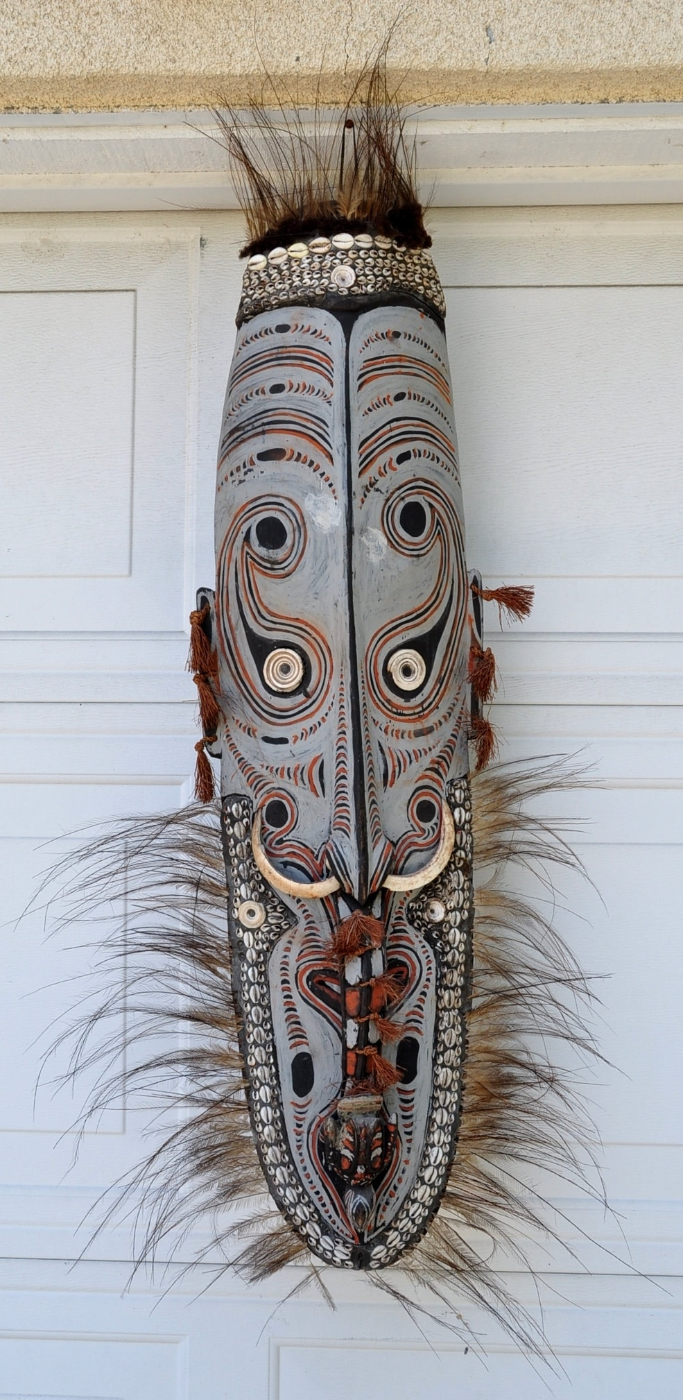 Papua New Guinea mask with cassowary feathers, cowrie shells and boar's tusks