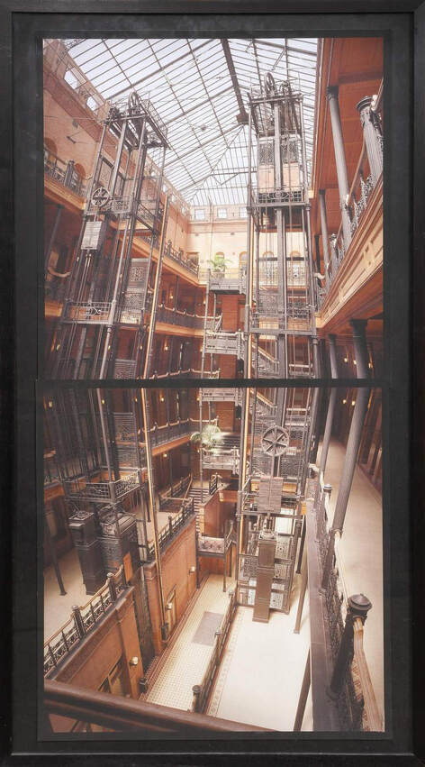 Large framed photographs of the Bradbury Building by Michael Rauner