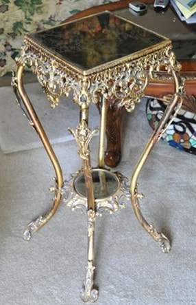 Ornate metal plant stand with mirror top