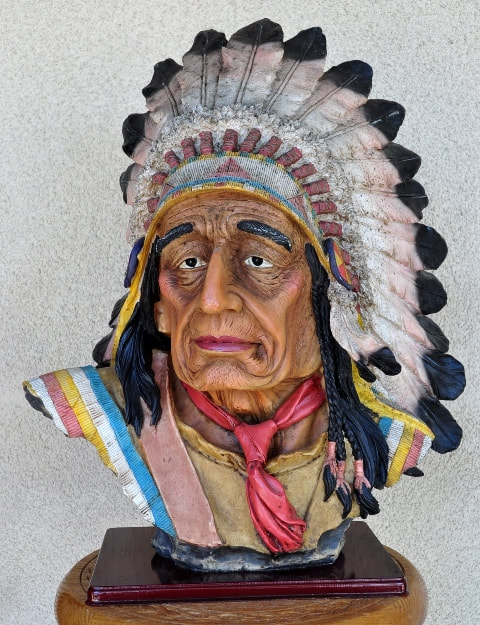 Large bust sculpture of a Native American chief with headgear