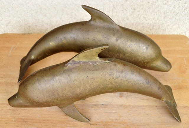 Pair of brass dolphin sculptures