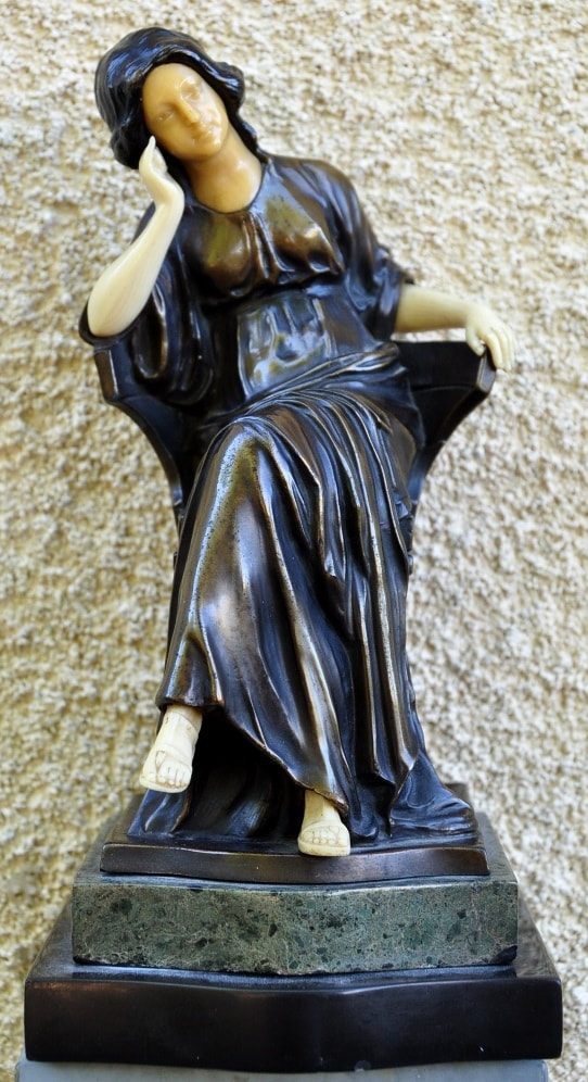 Renaissance style patinated metal and ivorine sculpture of a seated woman