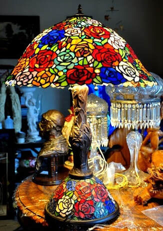 Tiffany style table lamp with a huge shade of with roses of several colors
