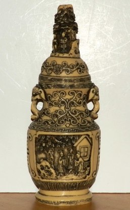 Urn with lid decorated with 3D relief carvings