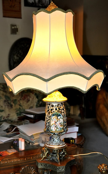 Pair of antique lamps with gilt reticulated porcelain vase and brass cherub base