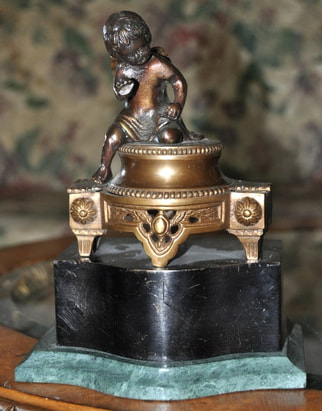 Brass bookend with bronze cherub sculpture 
