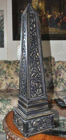 Wooden obelisk with 3D relief features