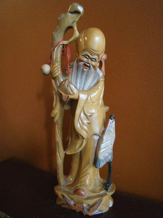 Wood carved statue of Tao god of longevity Shou Lao