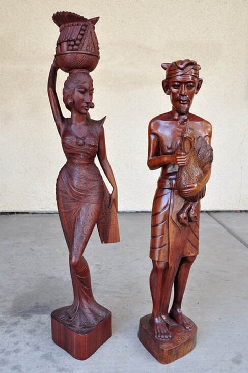Pair of Balinese hand carved hardwood sculptures of a man and a woman