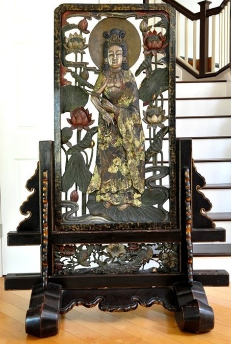Antique Oriental carved and pierced lacquered wooden screen depicting the Bodhisattva standing on a lotus leaf