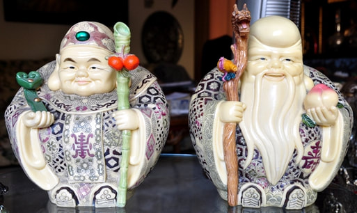 Pair of faux ivory sculptures of Shou Lao and another immortal