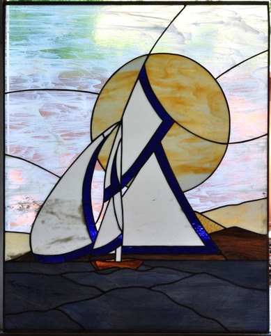 Stained glass window showing a sailing ship in the ocean