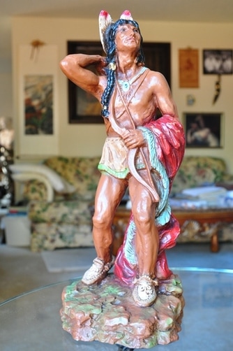 Sculpture of an Native American with bow and arrows