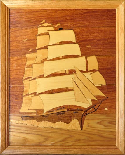 Large wood marquetry artwork depicting a sailing ship