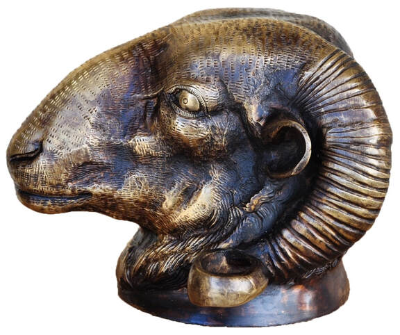 Antique cast bronze ram's head wall ornament with finely worked surface details