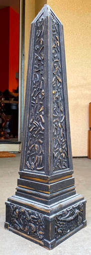 Wooden obelisk with 3D relief features