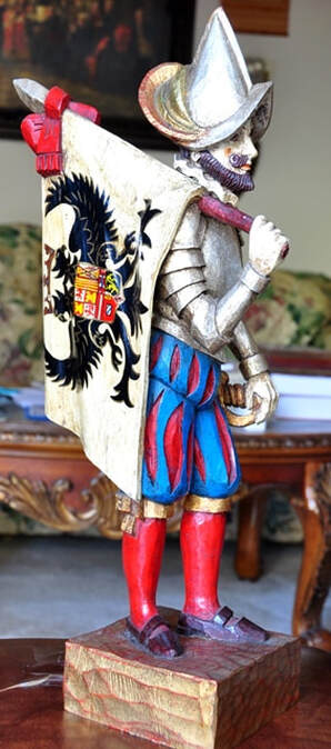 Wooden sculpture of flag holding Spanish Conquistador soldier