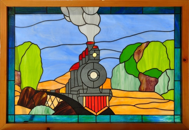 Stained glass window depicting a steam locomotive train​