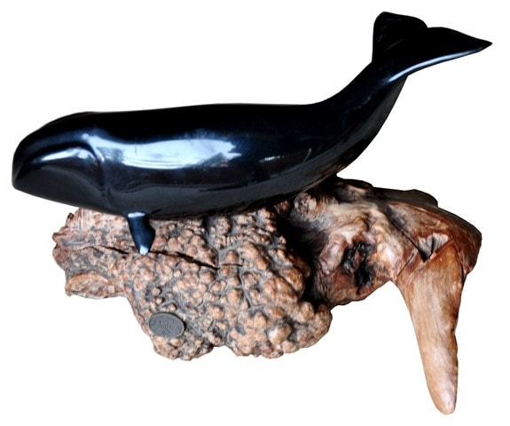 Whale and seal statues on driftwood by John Perry