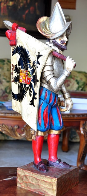 Wooden sculpture of a flag holding Spanish Conquistador soldier