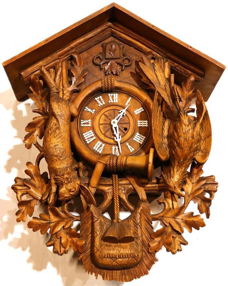 Large Black Forest carved wood cuckoo clock with hunting trophies